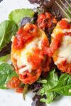 stuffed pasta shells on bed of lettuce on plate p
