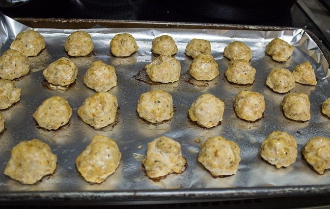 Chicken Meatballs baked on one side so far on pan