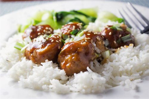 Baked Chicken Meatballs on rice on plate