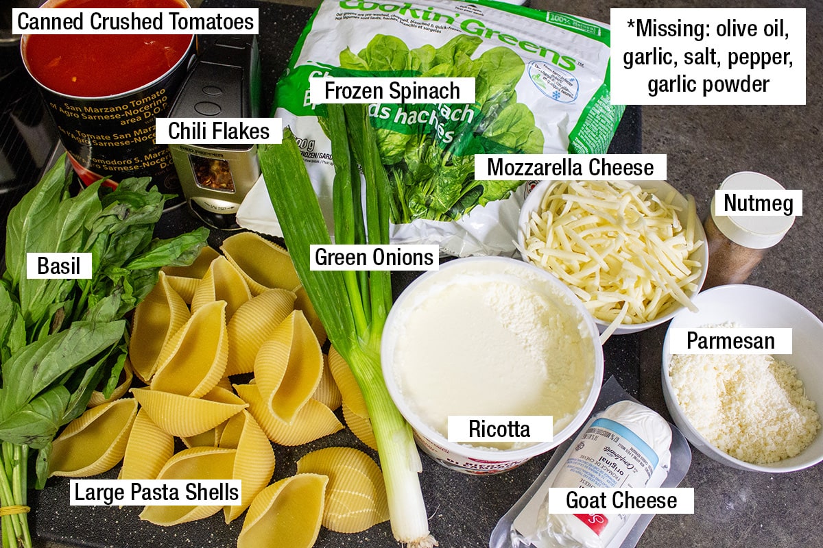 large pasta shells, ricotta, goat cheese, Parmesan, green onions, frozen spinach, canned crushed tomatoes, basil, nutmeg, chili flakes, olive oil,
garlic, salt, pepper,
garlic powder.