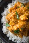 Indian butter chicken on rice in bowl