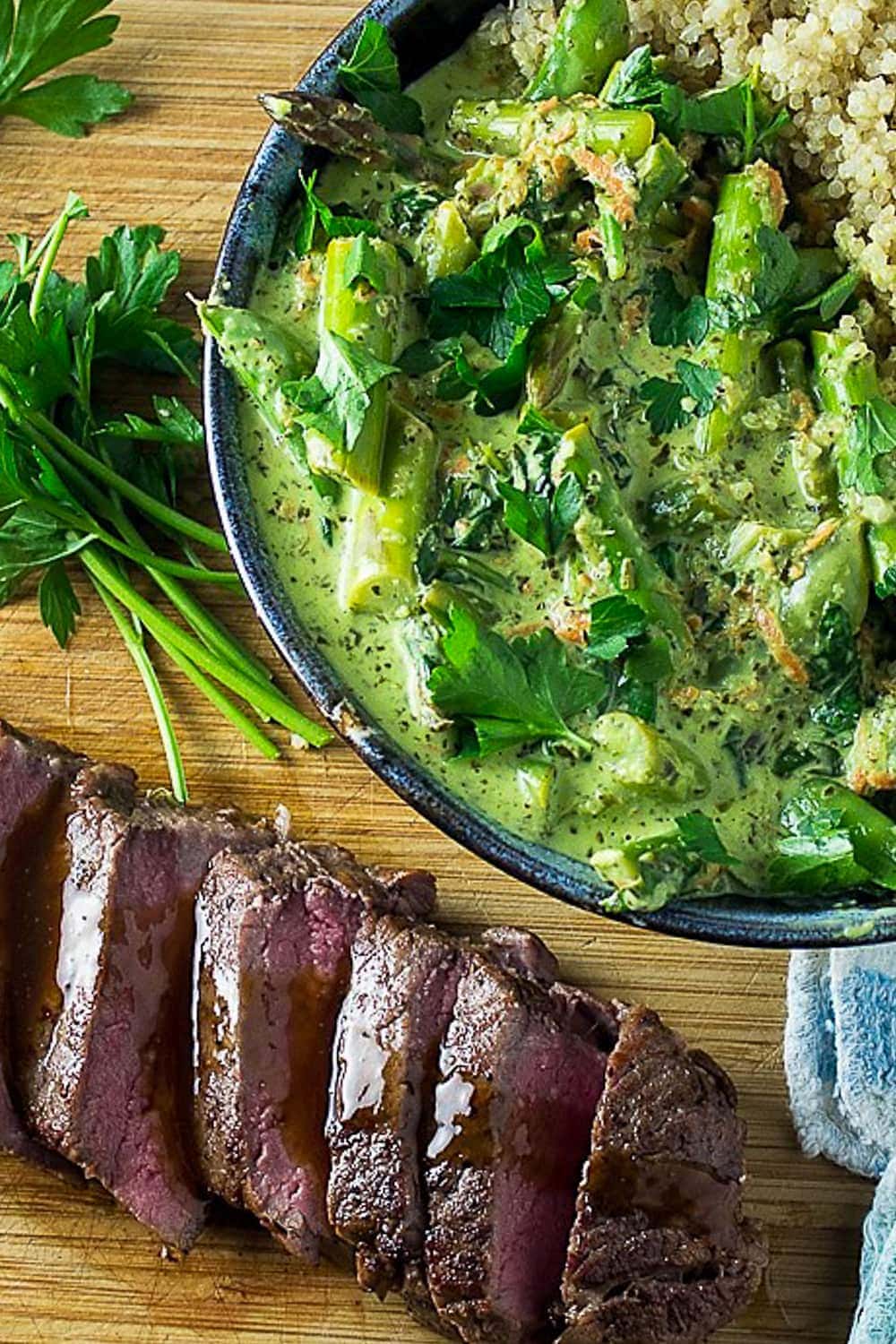 bowl of vegetable green curry with steak on cutting board