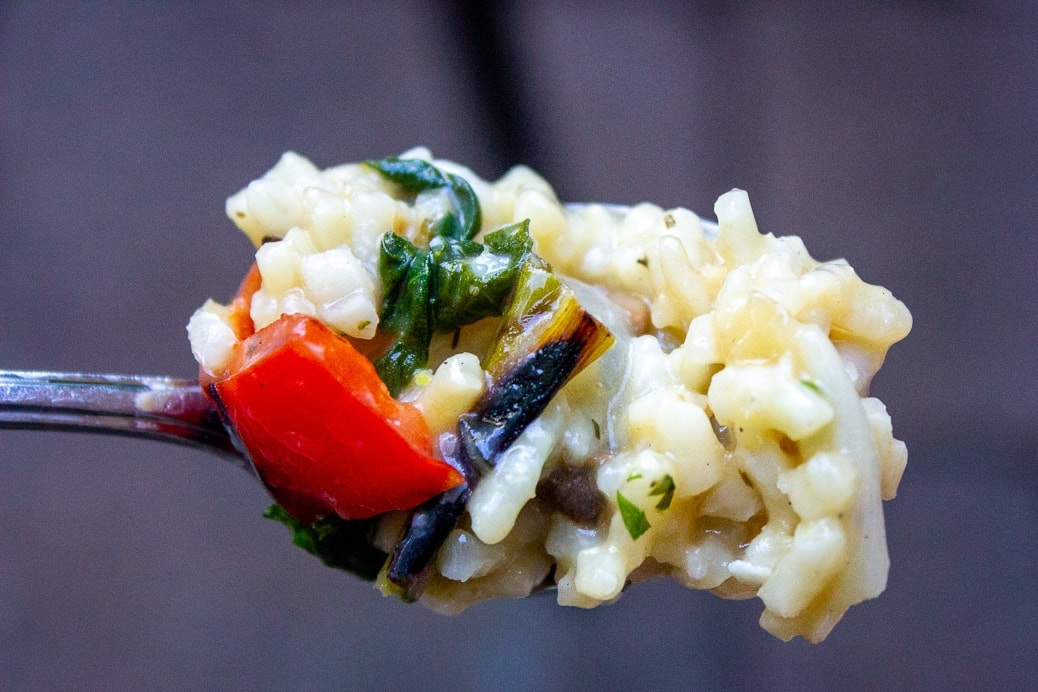 one forkful of instant pot risotto with grilled vegetables