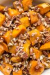 bowl of glazed sweet potatoes with pecans p1