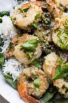 shrimp piccata on a platter sprinkled with parsley