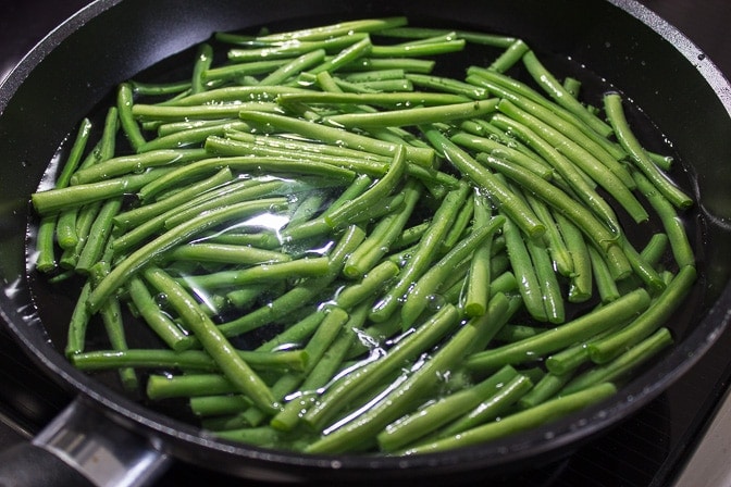 Green Beans simmering in water in a pan