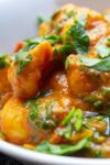 Indian style Gnocchi with Spinach in bowl sprinkled with parsley p
