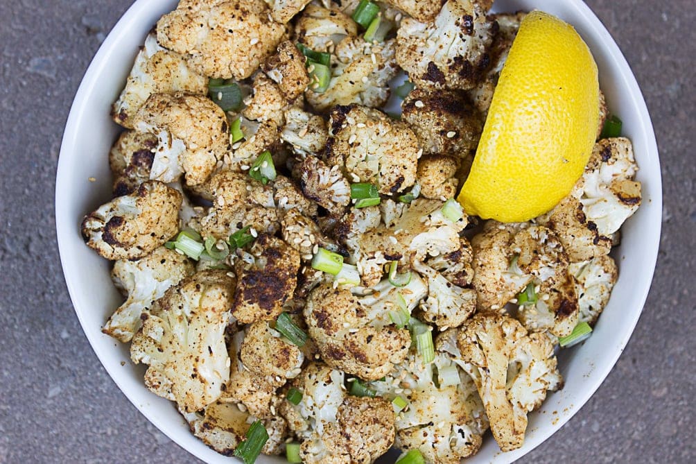 Grilled Cauliflower in a bowl with slice of lemon