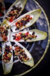 Endive Appetizers fanned out on a black plate
