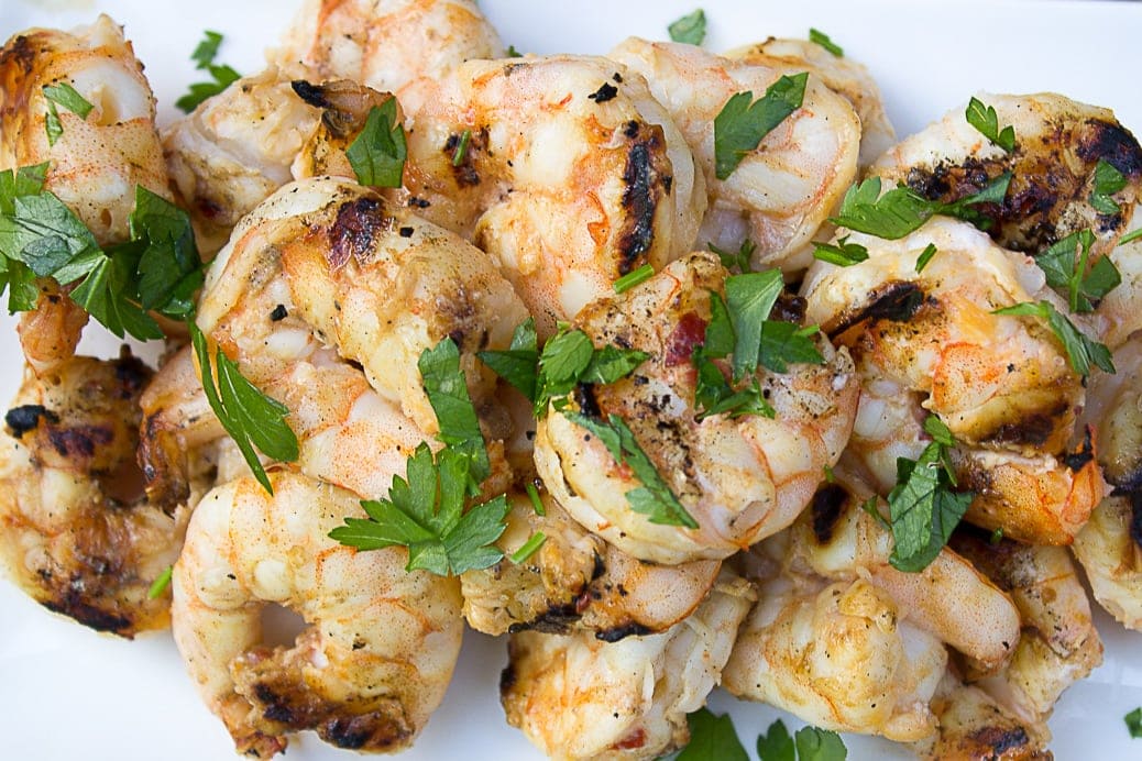 grilled marinated shrimp piled on a cutting board