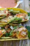 2 Grilled shrimp tacos with coconut lime chili sauce on platter p2