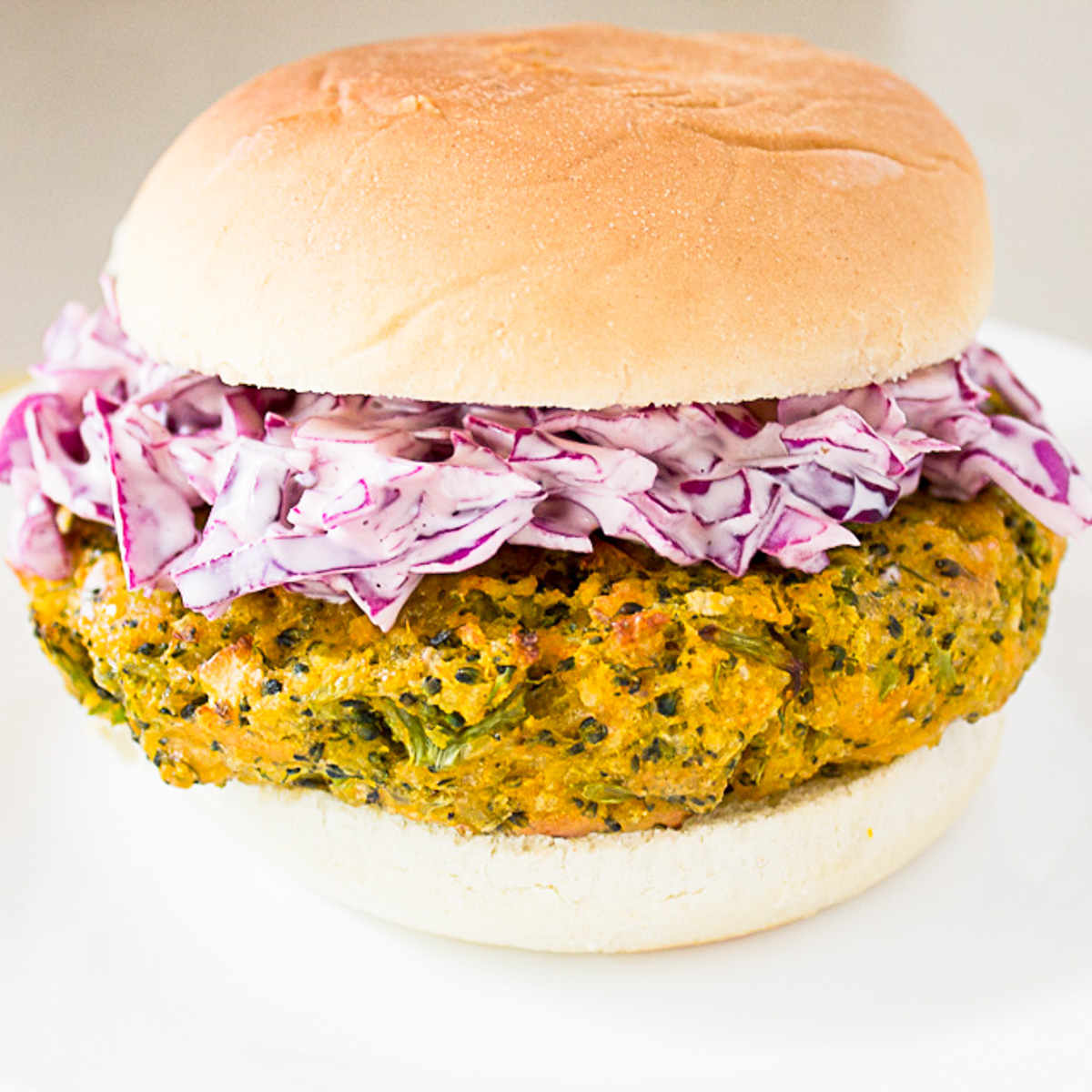 veggie burger with coleslaw in bun on plate