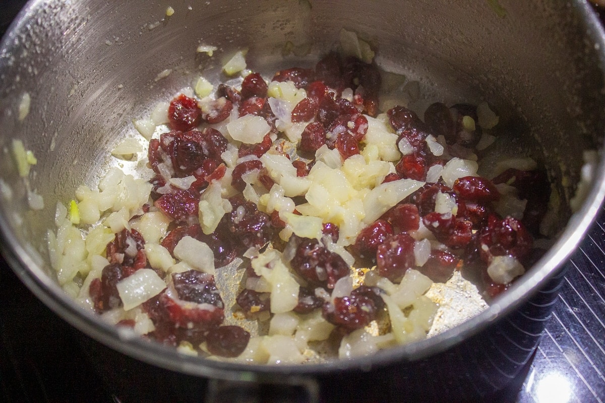 onions and cranberries in pot
