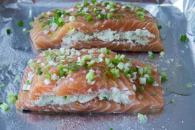 two pieces of Salmon Stuffed With Lemon Ricotta on pan ready to bake