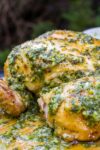spatchcocked Chicken With Herb Garlic Lemon Smear on top and on cutting board p