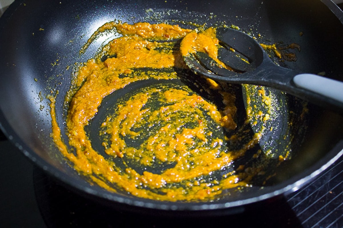 red curry paste and seasonings in pan