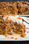 piece of baked carrot cake oatmeal on plate with sour cream and syrup p