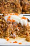 piece of baked carrot cake oatmeal on plate with sour cream and syrup p1