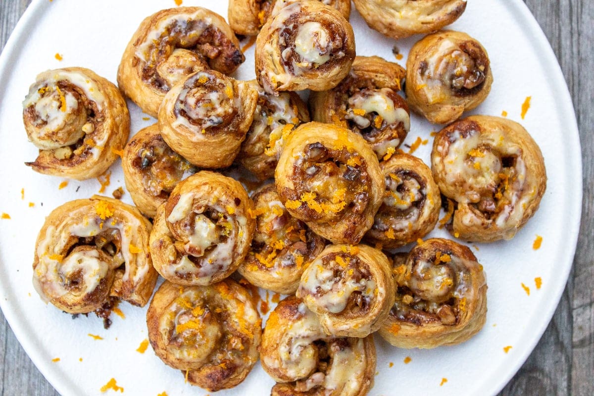 mini cinnamon puff pastry rolls piled on plate 2