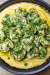 polenta on plate topped with herb shrimp p