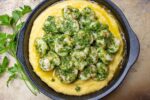 Herb Shrimp on Polenta on a black plate 5