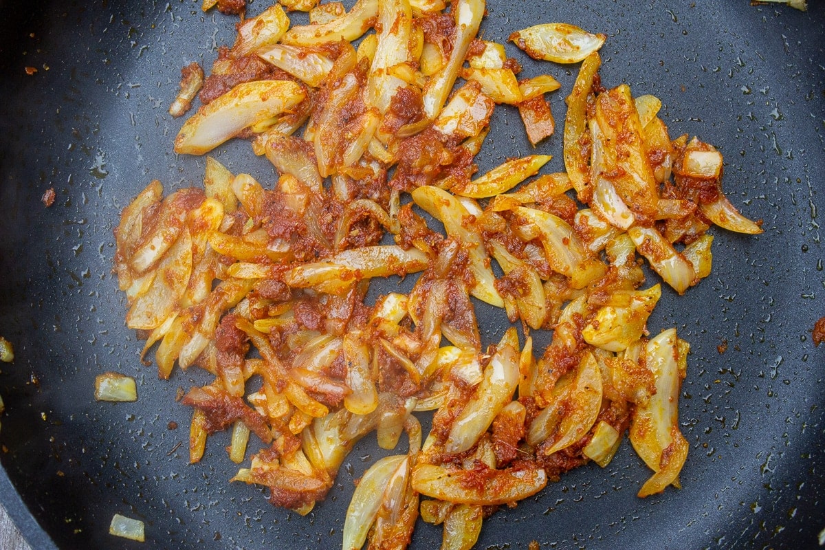 sauteed onions with curry and garlic in pan