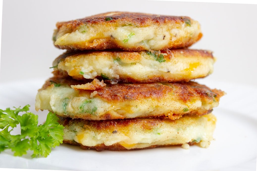 4 mashed potato pancakes (latkes) stacked on plate