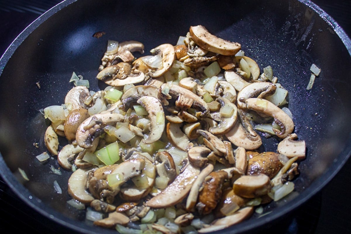sauteed mushrooms and onions in pan