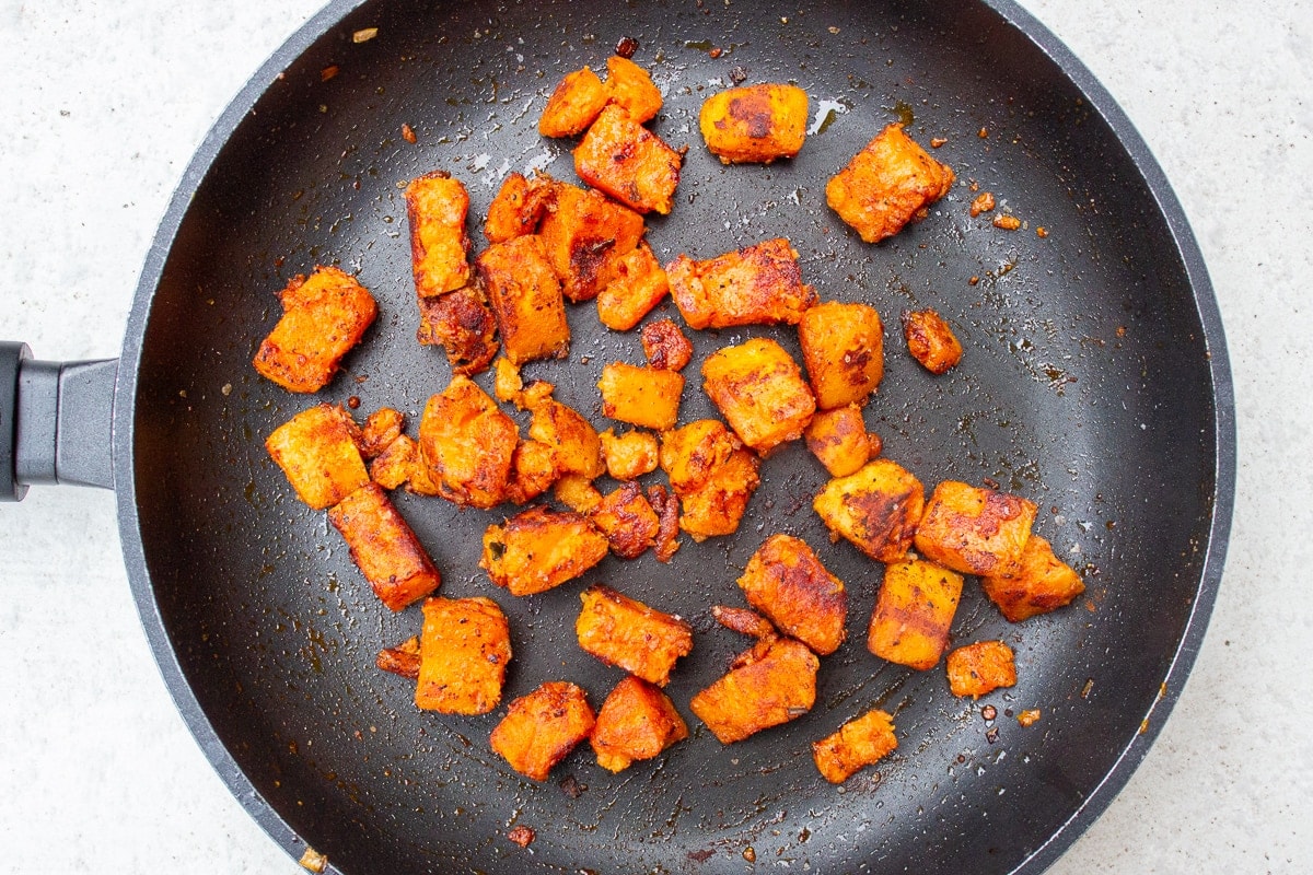 browned sweet potato cubes in skillet