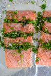 two raw close up of fillet of oasted Salmon Stuffed With Herbs on pan ready to bake p