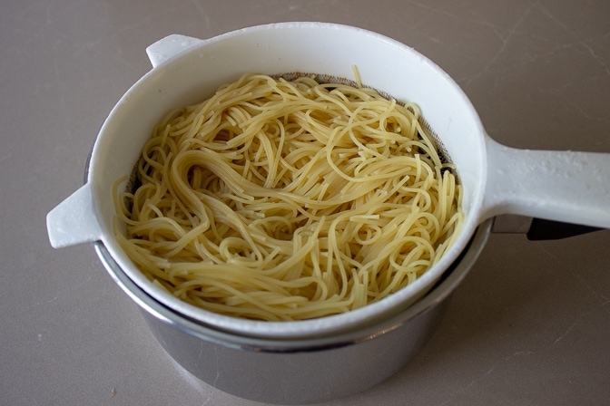spaghettini draining in strainer