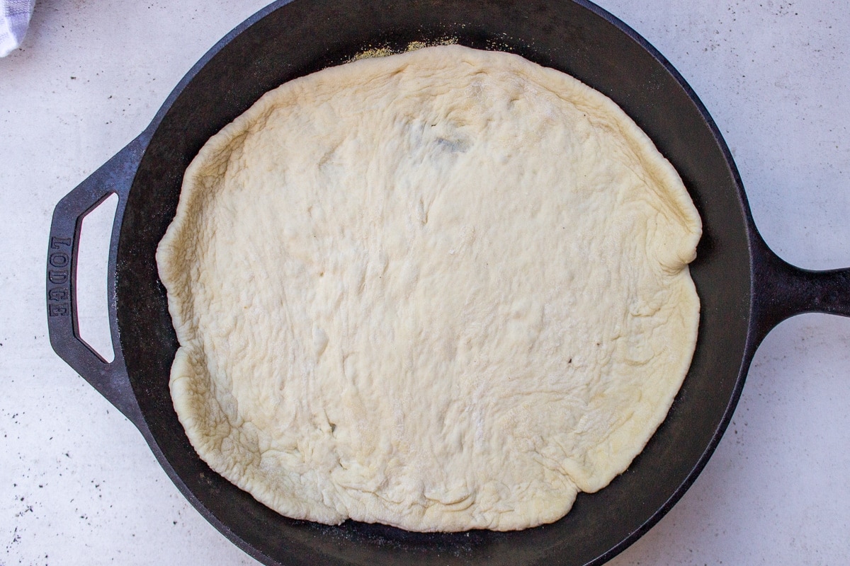 pizza dough laid in skillet