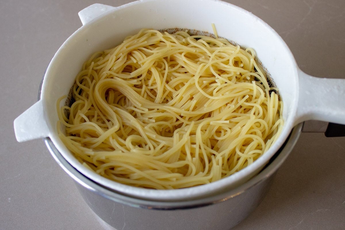 Spaghettini draining in strainer.