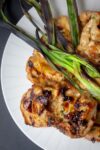 Grilled Vietnamese Chicken on plate with grilled scallions
