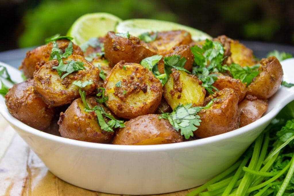 bowl of indian potatoes with lime wedges 1