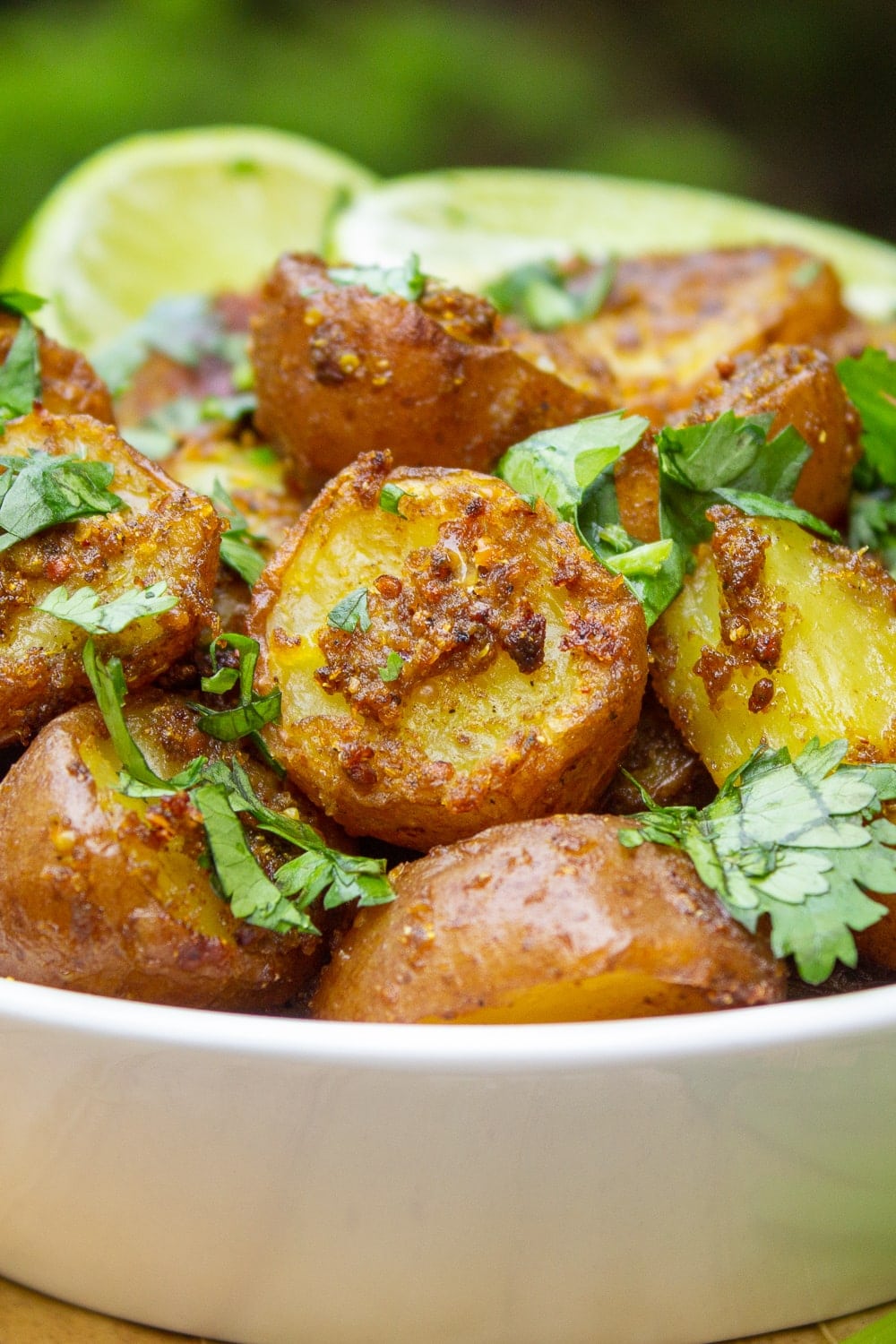 bowl of indian potatoes with lime wedges p7