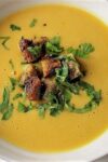 hai butternut squash soup in a bowl with cilantro garnish p1