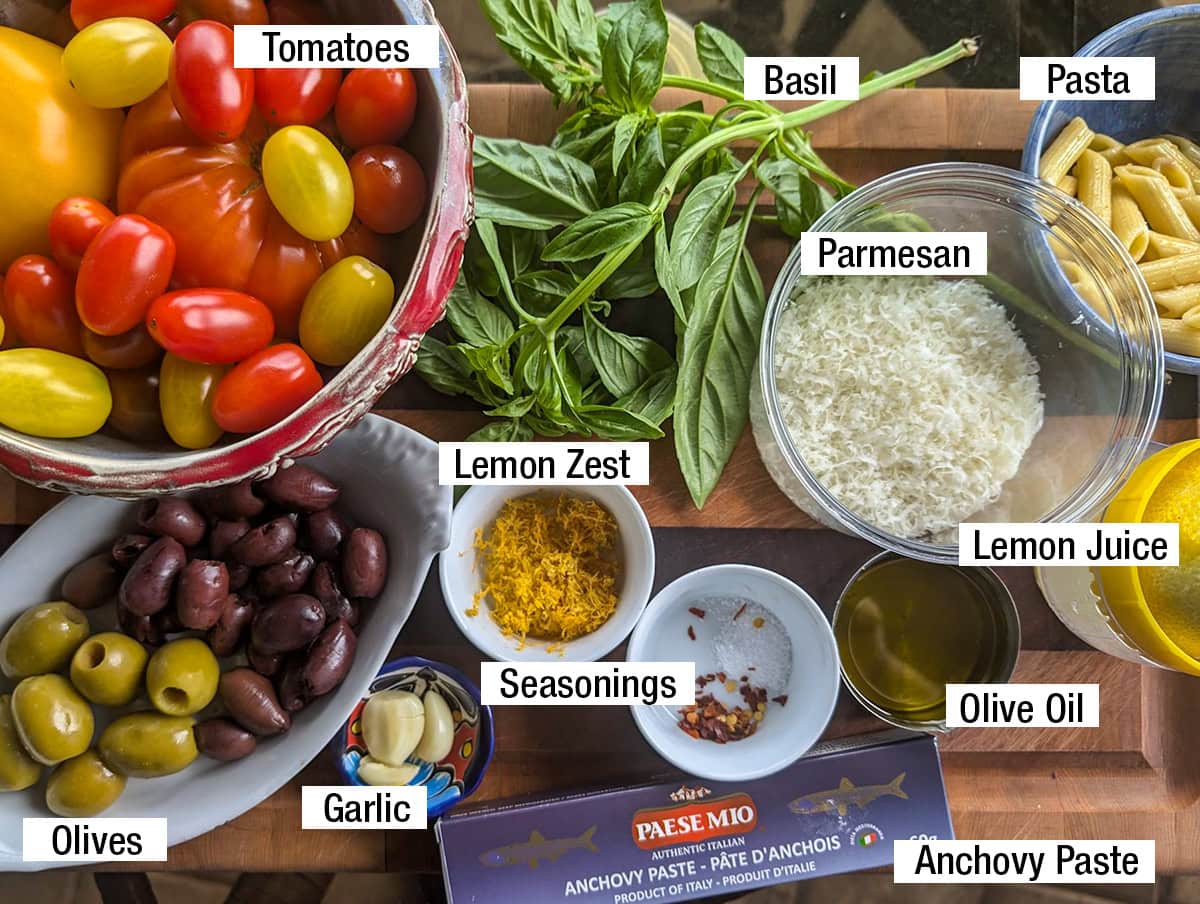 Pasta, basil, lemon zest, olives, tomatoes, garlic, parmesan, olive oil, anchovy paste (or capers), lemon juice.