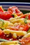 fresh tomato pasta with lemons and olives close up in bowl p5