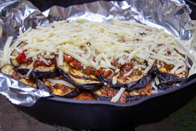 Fully assembled Eggplant Parmesan on pan ready to bake