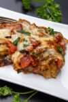 piece of Eggplant Parmesan on plate with fork p3
