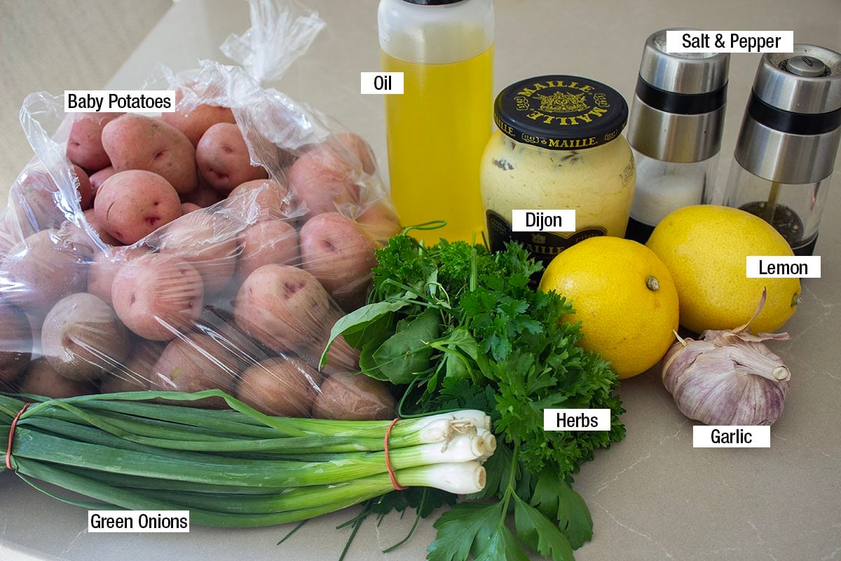 Baby potatoes, Dijon, oil, lemon, herbs, green onions, salt,  pepper, garlic.