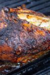 half turkey breast grilling on grill