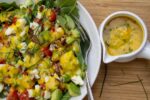 Mango Salad Dressing on salad with dressing in cup on the side