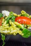 pesto orzo and vegetables on a spoon p1