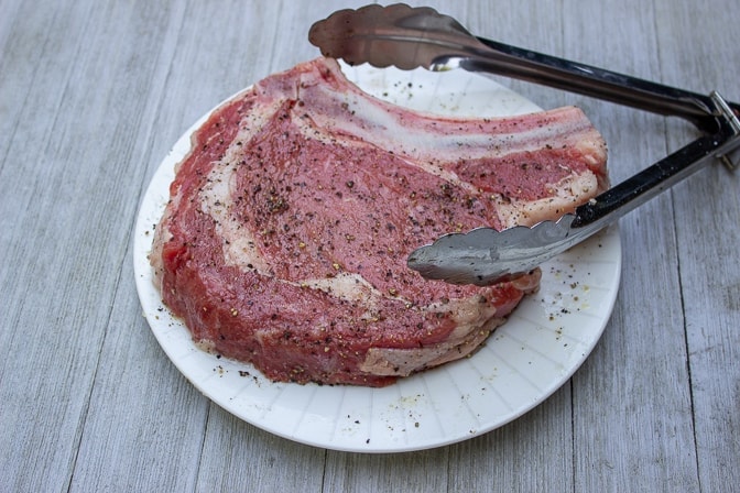 seasoned raw steak on plate