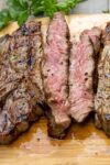 sliced grilled rib steak on cutting board p
