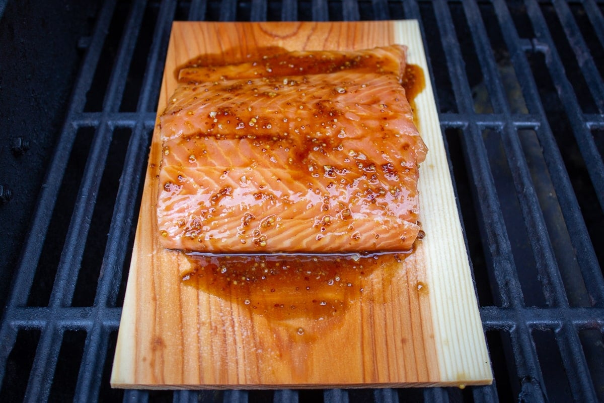 raw salmon on plank with glaze