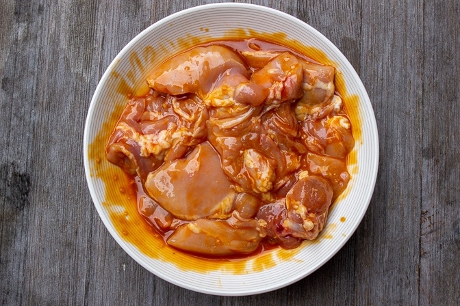 boneless chicken thighs marinating in bowl