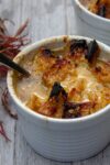 French onion soup in bowl on gray wood board